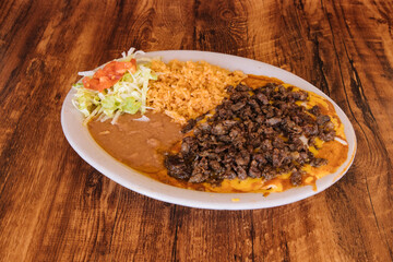 Mexican food enchiladas topped with beef and cheese