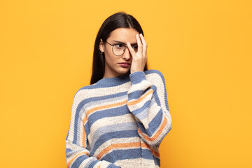 young hispanic woman feeling bored, frustrated and sleepy after a tiresome, dull and tedious task,...