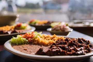 Mexican food beef beans and rice sitting in the sunlight