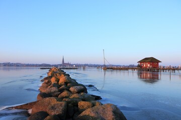 Idyllic view over the half frozen Schlei fjord to the the munumental Cathedral of St. Peter.