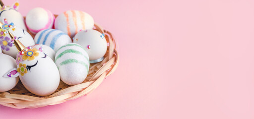 Fototapeta na wymiar Unicorn eggs in the box isolated on pink background. Happy easter. Kids activity.