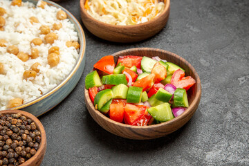 Side view of peas and rice meal sauerkraut salad on dark background
