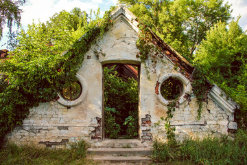 white cracked plaster on a brick wall at the entrance to an abandoned ancient greenhouse