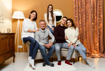 new year of a big joyful family. two generations of the family. Christmas in a homely atmosphere. New Year's decor in the room. family holiday. holiday mood. a group of people of different ages.