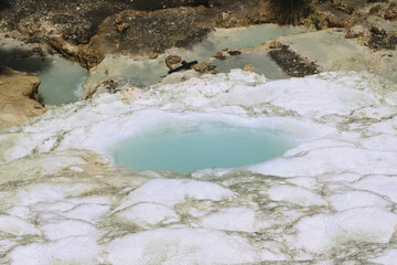 natural outdoor thermal spring free to the public in the woods, large limestone conformations from where hot water comes out