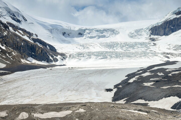 The Athabasca Glacier in the Columbia Icefield in Alberta, Canada. The scale can be seen middle left by the trucks and people on the glacier.