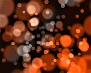 Beautiful, bright, colourful bokeh effect with dark background in warm shades