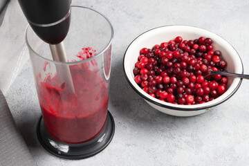 Grind fresh cranberries in a blender. Cooking homemade dishes from fresh berries