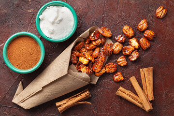 homemade candied pecans with cinnamon and sugar on rustic surface