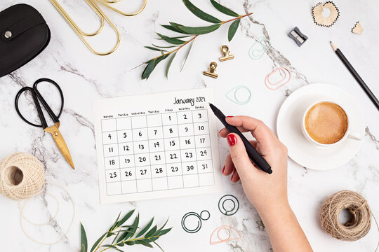 Desktop with calendar for january 2021 and office supplies. home office, social media blog, schedule, planning concept