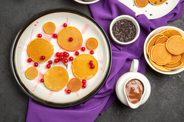 top view delicious little pancakes with cookies on a dark background milk dessert sweet