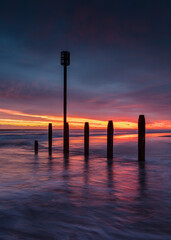 Colourful sunrise over Blyth Beach on the coast of Northunberland, England, UK. On a cold winter morning.