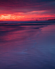 Fototapeta na wymiar Colourful sunrise over Blyth Beach on the coast of Northumberland, England, UK.