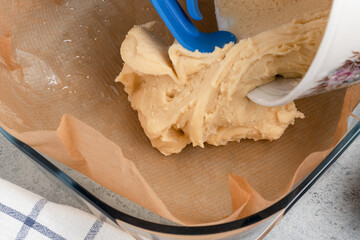 Putting the pie dough into a baking dish