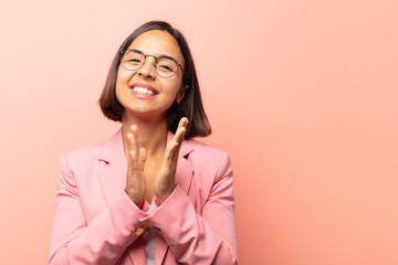 young hispanic woman feeling happy and successful, smiling and clapping hands, saying congratulations with an applause - obrazy, fototapety, plakaty