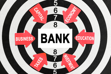 On the target, arrows with business lettering point to the center on a business card with the inscription - BANK