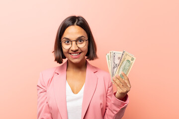 young hispanic woman looking happy and goofy with a broad, fun, loony smile and eyes wide open