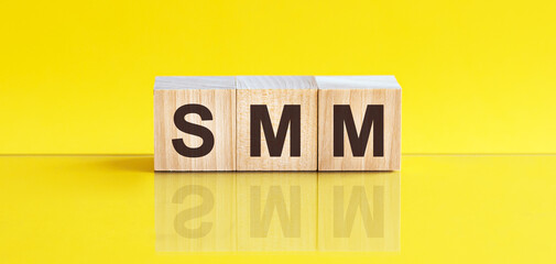 SMM - acronym from wooden blocks with letters, concept. SMM - Social Media Marketing