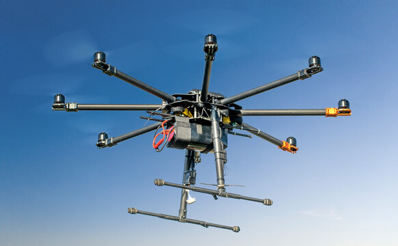 Big black homemade eight motor hexacopter on sky background.