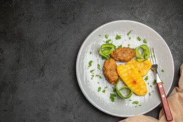 Above view of well-cooked cutlet dish and a fork
