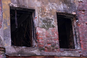 Broken glass in the windows of an old demolition house. An old abandoned building in the center of St. Petersburg.