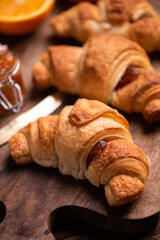 Fresh homemade croissants on wooden table