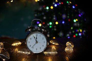 Fototapeta na wymiar New year composition with alarm clock and beautiful bokeh in the background