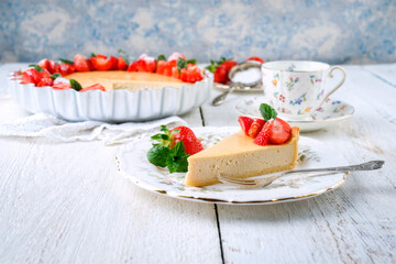 Traditional German cheesecake with strawberry fruits served as close-up on a classic design plate on a wooden table