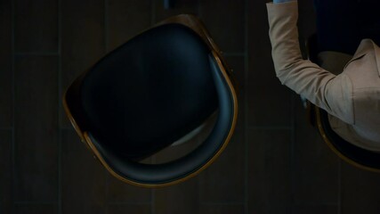 Businesswoman sitting with colleague in office. Team using digital devices.