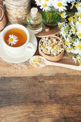 herbal chamomile tea and daisy flowers.	

