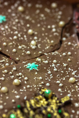 Handmade milk chocolate bars decorated in New Year's style - with snowflakes and white pearl beads. Sweet gift for Christmas