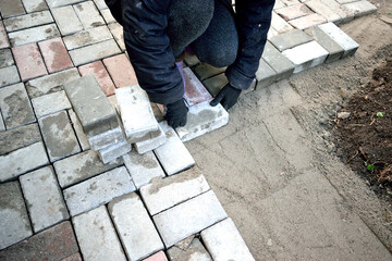 work near the house, laying paving slabs, close-up