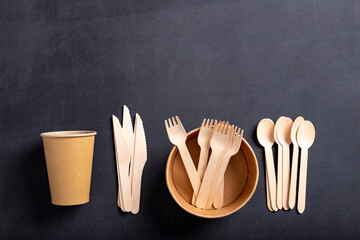 Wooden cutlery and paper disposable tableware on the table. Utensils used in the fast food bar.