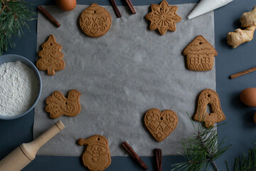 Gingerbread cookies on baking paper. Homemade holiday baked goods. Concept for Christmas dishes. Horizontal orientation. Top view. Copy space.