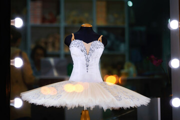 White ballet tutu on display in ballet store accessory. Showcase of ballet accessories shop, professional tutu and costume © Tricky Shark
