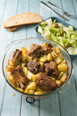 Top angle view on bowl with potatoes and meat ribs salad and bread on table