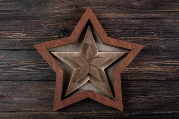 Fototapeta na wymiar Empty star shaped wooden box on wooden background