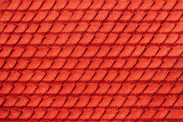 Texture of genuine rough leather close-up, imitation of skin scaly exotic reptile, fashion red color, modern background