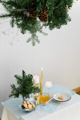 Aesthetic design for christmas with pine nobilis hanging garland, candles and table decorations 