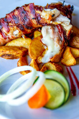Tasty chicken meat with potatoes and vegetables. Roasted chicken meat in the white plate.