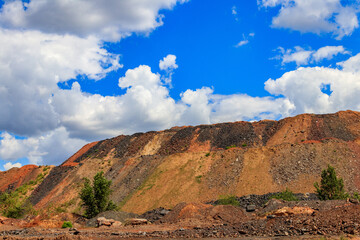Fototapeta premium View of slag heaps of iron ore quarry. Mining industry