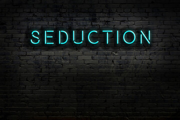 Night view of neon sign on brick wall with inscription seduction - obrazy, fototapety, plakaty