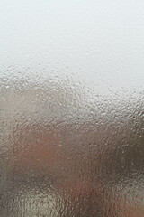 Street view through an ice-covered window outside. Dull cloudy winter day.