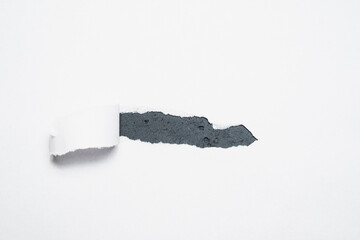 A piece of paper torn off revealing the contents. The concept of discovering content, supplementing with content.