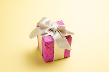 front view cute little present on light-yellow background holiday xmas gift color new year photo