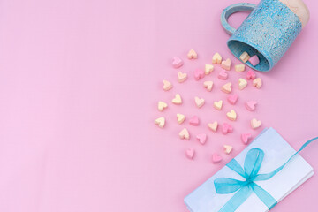 heartshaped marshmallow and envelopes with blue ribbon
