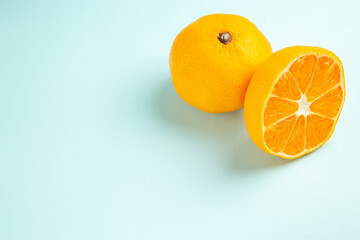 front view fresh tangerine slices on light-blue background fruits color orange photo juice citrus