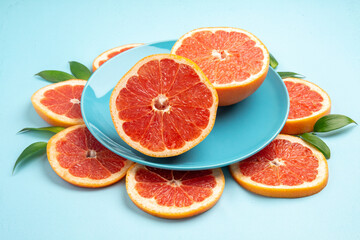front view tasty grapefruits fruit slices on blue background fresh color citrus fruits juice mellow