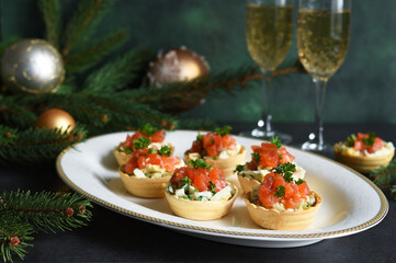 Tartlets stuffed with salad and salmon on a New Year's table.