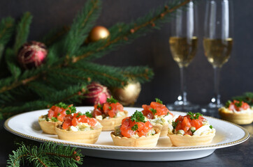 Tartlets stuffed with salad and salmon on a New Year's table.
